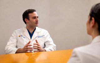 Dr. Farah Musharbash discussing treatment options during a collaborative spine case review at Atlantic Brain and Spine.